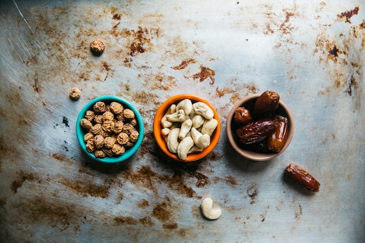 Variety of healthy whole foods including vegetables, nuts, and lean proteins